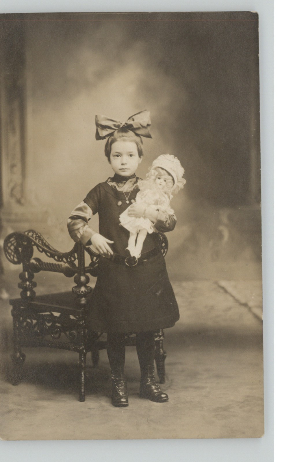 Antique c1910 RPPC Girl Holding Creepy Doll Big Bow Child Portrait Edwardian
