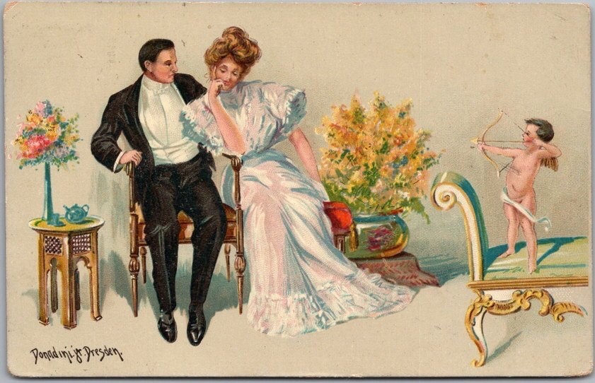 1910 VALENTINE’S DAY Romance Postcard Cupid Aiming Arrow at Couple -Donadini Jr.