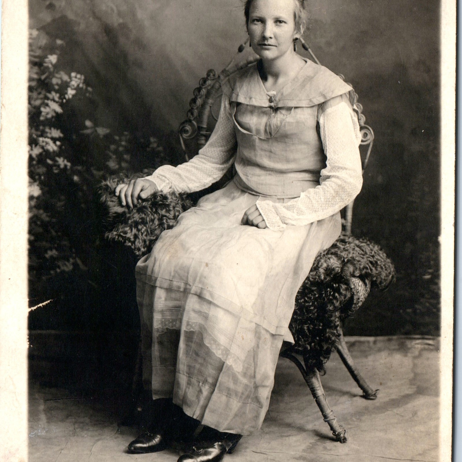 c1920s Young Woman Seated RPPC Postcard Wicker Chair Portrait Unique Sleeves