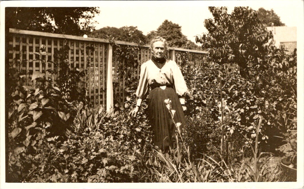Older Woman in Garden Postcard RPPC 1900s Puffed Sleeves Lattice Fence