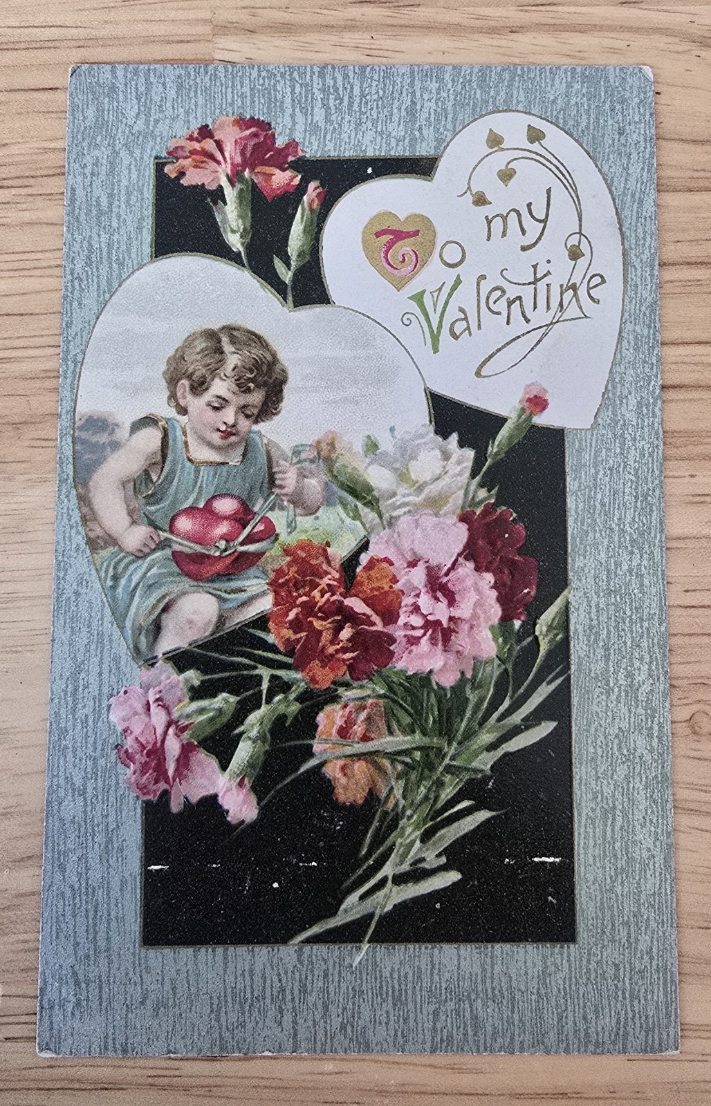 Vintage Embossed Valentine’s Day Postcard Cherub Holding Hearts Flowers